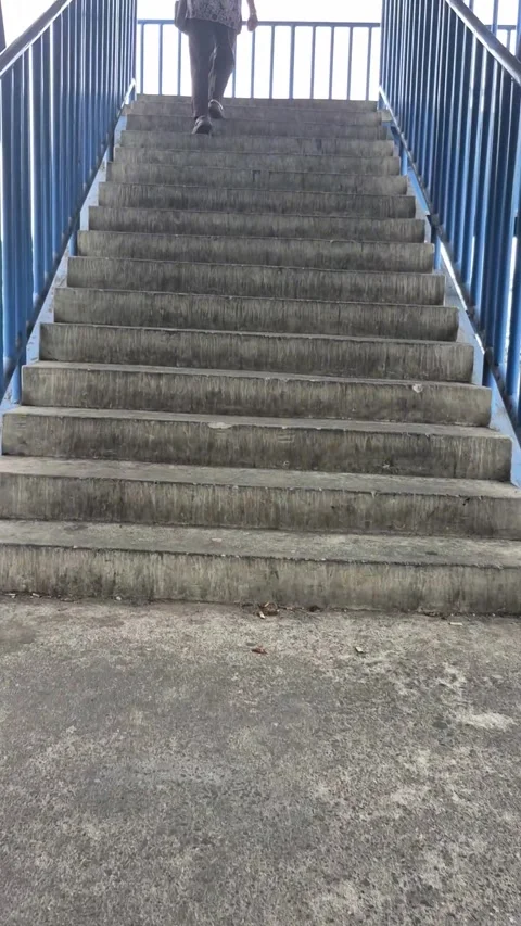 Low angle view of a person walking up Video stock 338222288