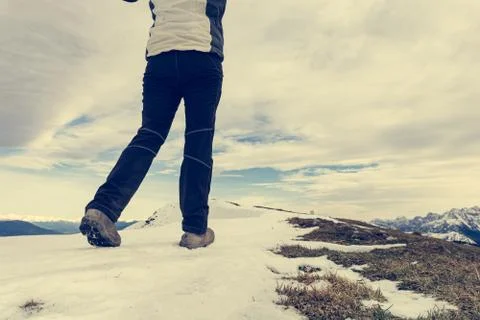 Low angle view of person walking on snow covered mountain ridge. Stock Photos