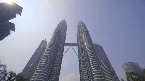 Low angle view of PETRONAS Towers against blue sky Stock Footage 111279732