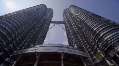 Low angle view of PETRONAS Towers against blue sky Stock Footage 122449629