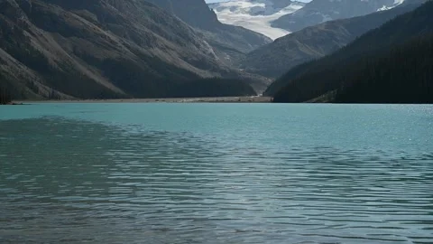 Low angle view of Peyto Lake near Banff with turquoise water and gentle waves in Stock Footage 332720038