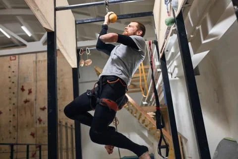 Low angle view of physically challenged boulderer working out at gym Stock Photos