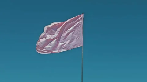 Low angle view of a pink waving flag against blue sky Stock Footage 285639090