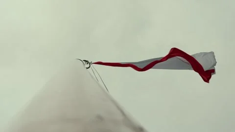 Low angle view of polish flag waving in the wind against cloudy sky Stock Footage 312208242