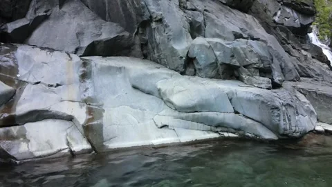 Low angle view of polished rock walls and stream Stock Footage 331900678