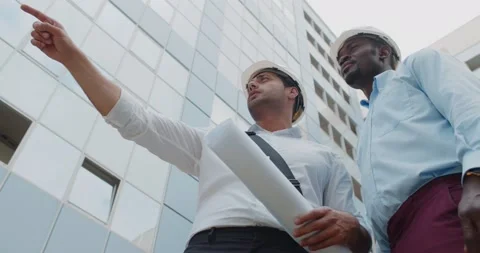 Low angle view of professional architect and engineer discussing outdoors Stock Footage 157766279