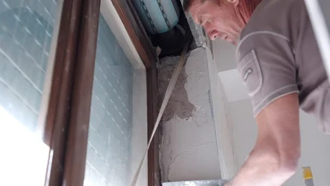 Low angle view of professional construction worker aligning and smoothing 스톡 동영상 162052688