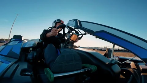 Low angle view of professional racer driving his go kart on a race track Stock Footage 172028607