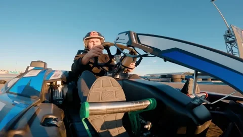 Low angle view of professional racer driving his go kart on a race track Stock Footage 172028627