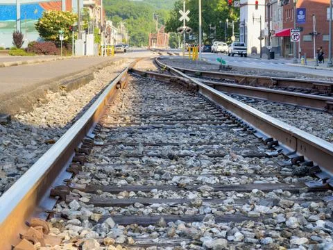 Low-angle view of railroad tracks and a switch running down a street Stock Photos