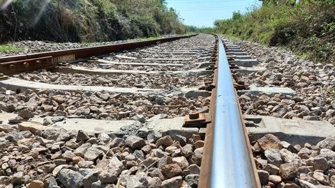 A Low Angle View Of Railway Tracks Receding Into Distance Stock Photos