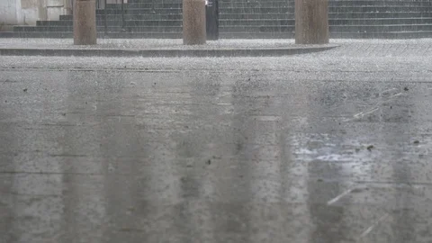 Low angle view of raindrops pattering down on the city square. Stock Footage 107950021