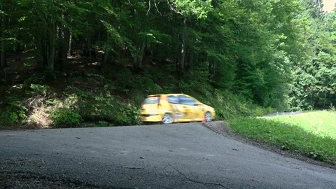 Low angle view of a Rally car going into a corner at high speed Stock Footage 218281615