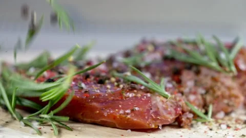 Low angle view on raw marbled meat seasoned with herbs and spice Stock Footage 162860141