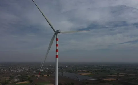 Low Angle View of Red and White Striped Wind Turbine Tower Against Cloudy Sky Vídeo Stock 342488267