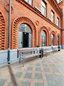 Low-angle view of a red brick building with ornate arches and black-framed 스톡 사진