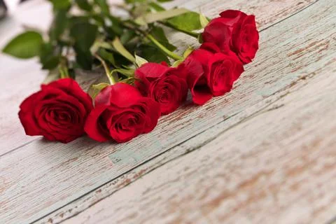 Low Angle View of Red Roses on Rustic Wood Table Stock Photos