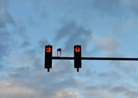 Low angle view of red  traffic lights   with the arrow pointing to ahead  and Stock Photos