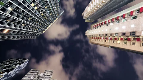Low angle view of residential buildings at night, clouds glide fast, timelapse Stock Footage 309363664