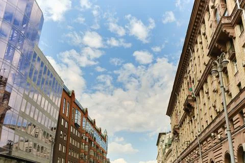 Low angle view of residential modern buildinds, windows and drainpipe. Blue sky Stock Photos
