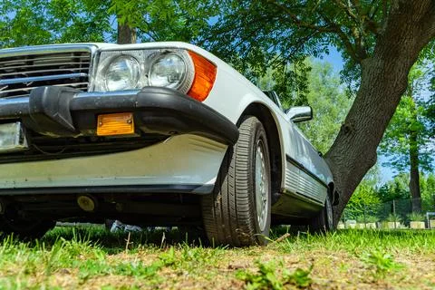 Low angle view Retro car of white color on the grass Stock Photos