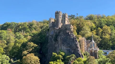 Low-Angle View of Rheinstein Castle Surrounded by Autumn Forest Vídeos de archivo 346845682
