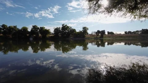 Low angle view of river with reflections on the water Stock Footage 299886847