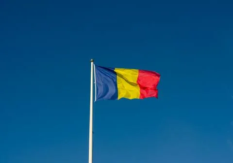 Low angle view of Romania flag  agains  blue sky. Foto stock