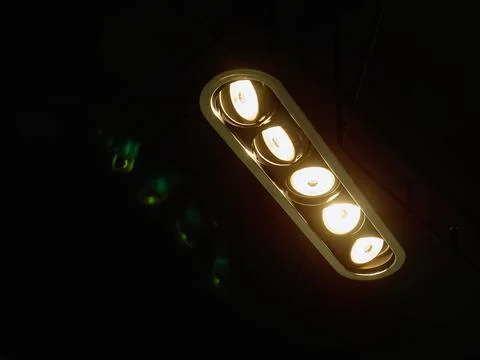 Low Angle View of a Row of Illuminated Light Bulbs in the Dark Foto stock