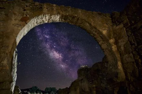 A low angle view of a ruined building under a starry sky at night - perfect f Fotos de archivo