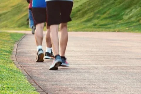 Low angle view of runners running in park. Stock Photos