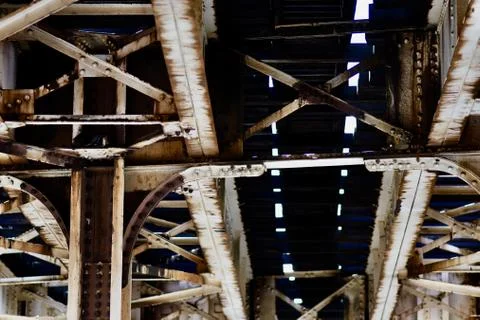 Low angle view of a rusty metallic ceiling of a factory under sunlight Stock Photos