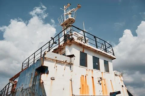 Low angle view of the rusty superstructure and bridge of an abandoned shipw.. Stock Photos