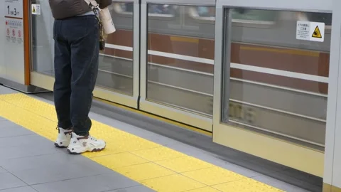 Low angle view to the safety door gate of the subway's door train on platfo.. Video stock 328102196