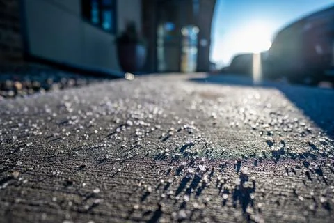 Low angle view of salt spread on sidewalk to melt ice and snow Stock Photos