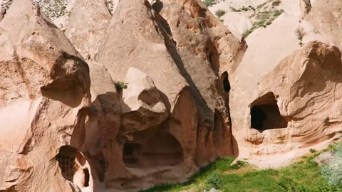Low angle view of scenic cave dwellings and rock formations in the ancient regio Stock Footage 332544974