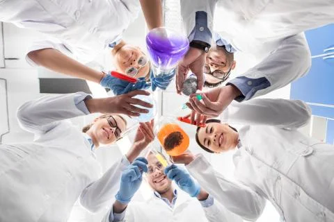 Low angle view of scientists holding various test tubes 写真素材