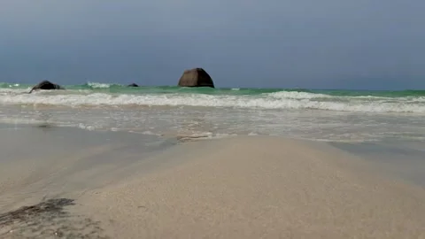 Low Angle View of Sea Waves Washing Shore with Granitic Rocks Background Stock Footage 340134791