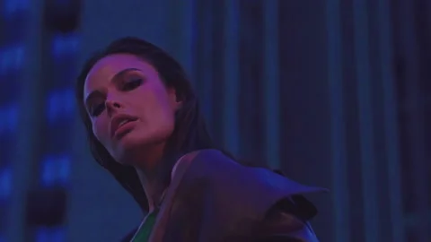 Low angle view of sensual stylish girl posing in neon night light outside Stock Footage 159974515