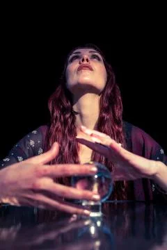 Low angle view of serious fortune teller using crystal ball Stock Photos