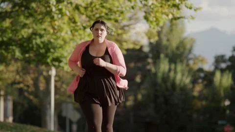 Low angle view of serious runner jogging outdoors Stock Photos