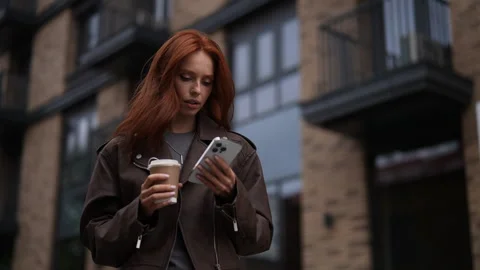Low-angle view of serious young woman with thoughtful expression standing in Stock Footage 283634167