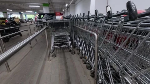 Low-angle view of shopping carts lined up in an underground parking garage Stock Footage 311154074