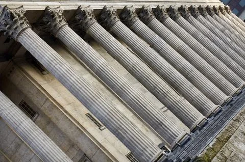 Low angle view showing the row of stone Corinthian columns on the facade of t Stock Photos