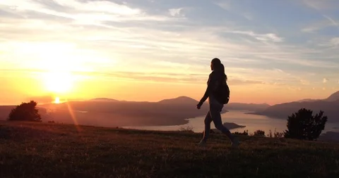 Low angle view of silhouette yong walking woman. Sporty woman walking at the Stock Footage 88071844