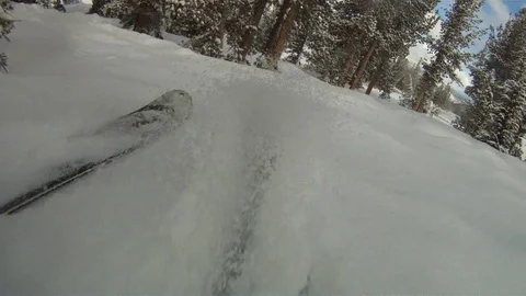 Low angle view of skiing down a slope at a ski resort Mammoth Mountain 動画素材 91054327