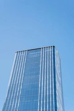 Low angle view of skyscraper with glass window and clear blue sky background Foto stock