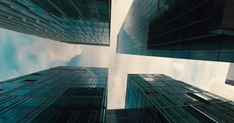 Low-angle view of skyscrapers with clouds in a blue sky Stock Footage 174668617