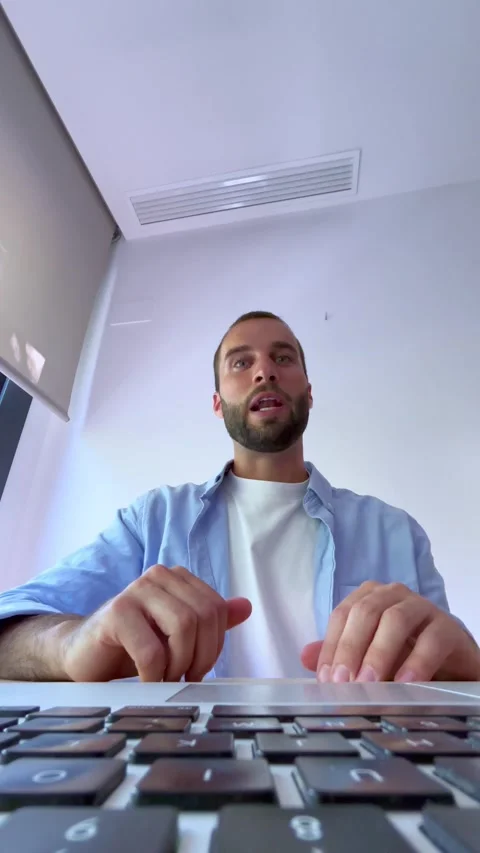 Low-angle view of a smiling young businessman waving hello, talking, and Stock Footage 344787530