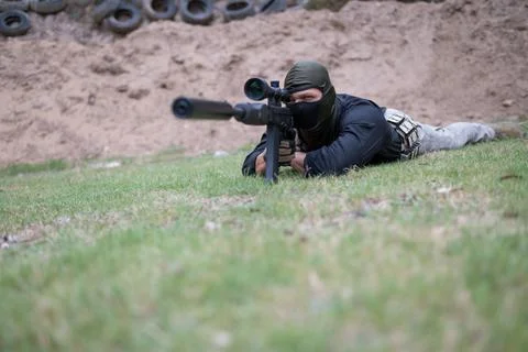 Low angle view of sniper laying on ground Stock Photos